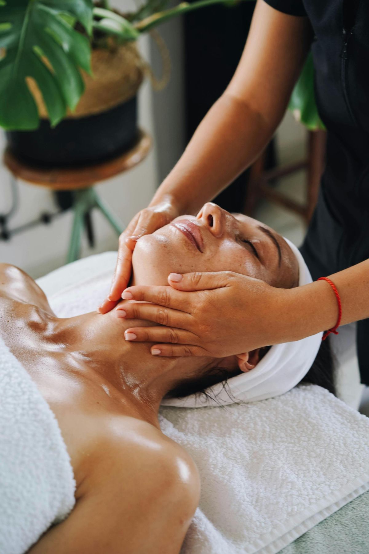 A woman relaxes during a facial at a spa